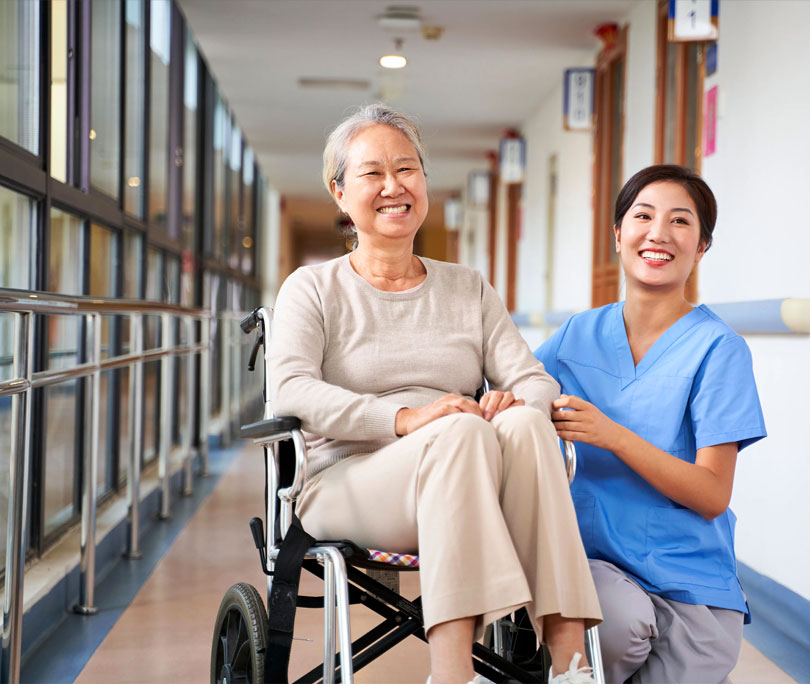 Stock Image of Nurse with Patient on Wheel Chair